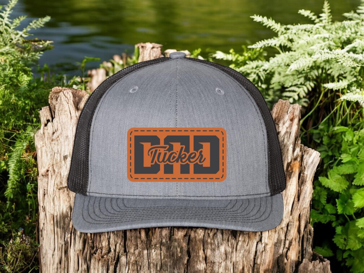 Grey trucker hat with a custom leather patch engraved with a child's name